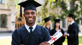 Man smiling in a cap and gown