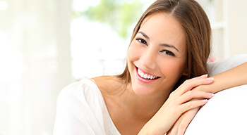 woman in white smiling bright