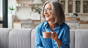 Somerville patient smiling with a cup of tea