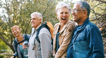 Denture patient in Somerville speaking with friends
