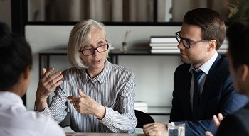 Smiling Somerville patient at work after denture treatment