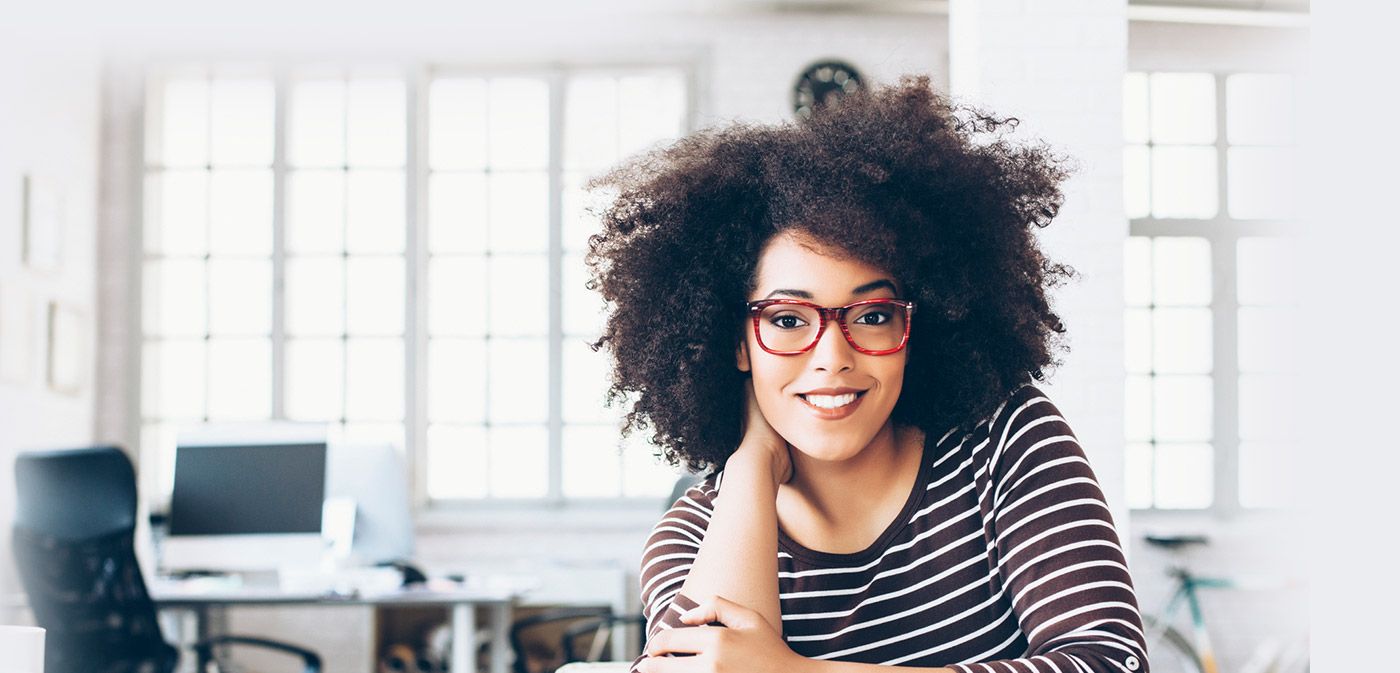 woman with red glasses smiling