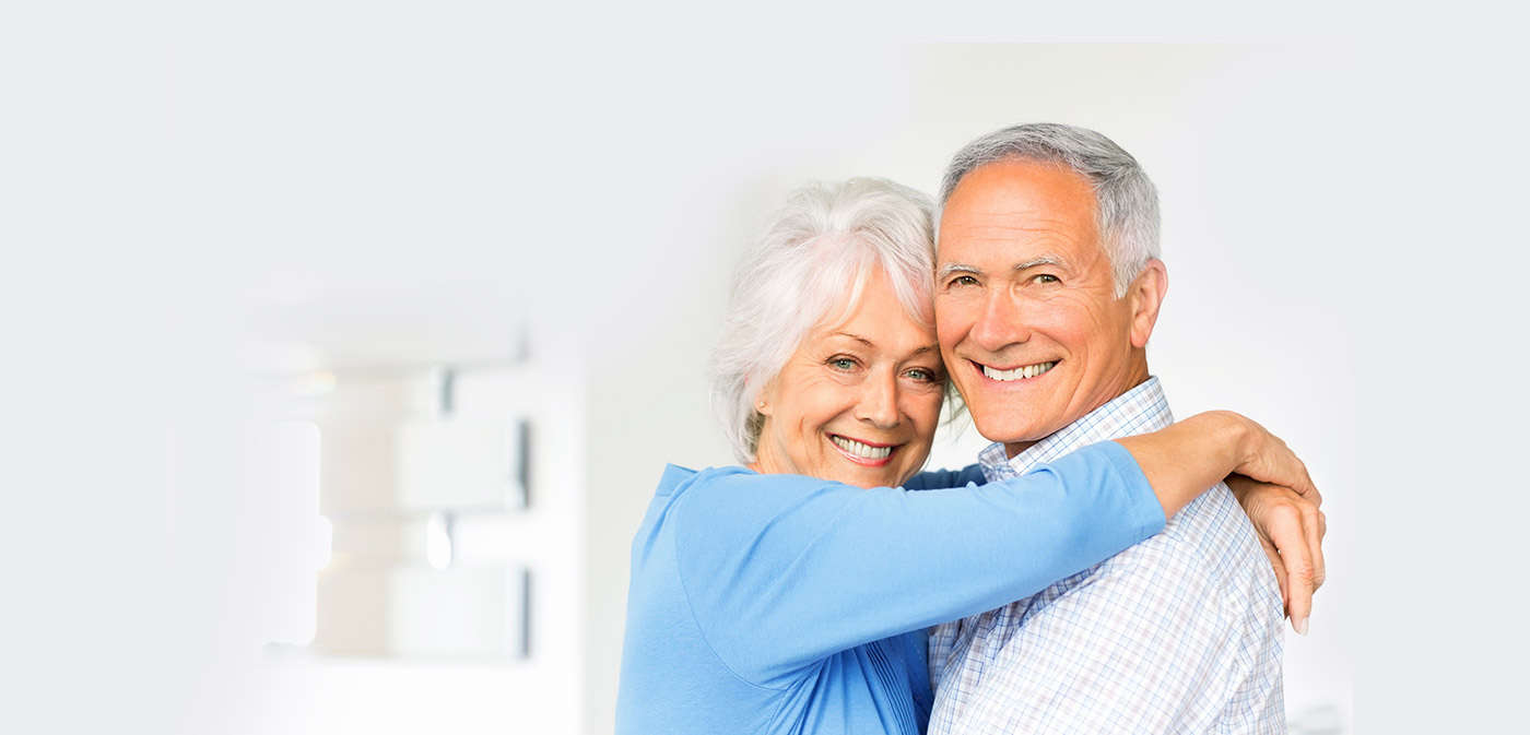 husband and wife hugging and smiling