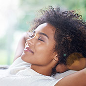 woman relaxing with hands behind head