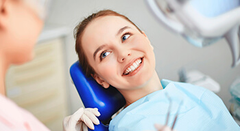 woman in dental chair smiling