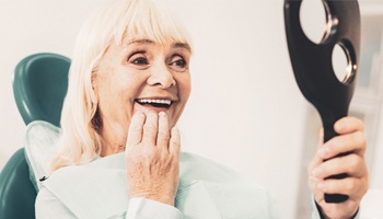 Woman looking at denture