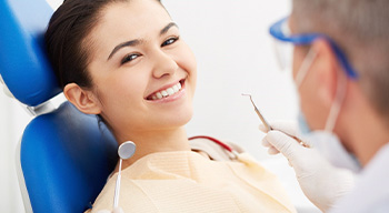 Dentist explaining benefits of dental implants in Somerville to patient