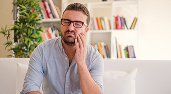 man with toothache who needs an emergency dentist in Somerville 