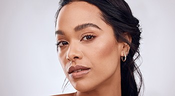 Portrait of beautiful woman with defined features and glowing skin