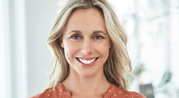woman wearing orange shirt smiling