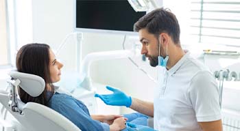 Dentist explaining benefits of dental implants in Somerville to patient