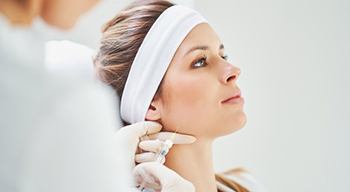 a patient receiving Jeuveau injections for TMJ treatment
