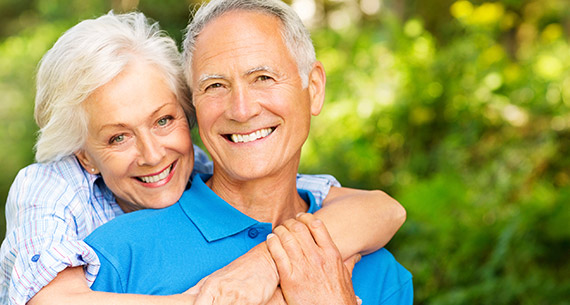 elderly husband and wife hugging