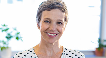 woman in polka dot shirt smiling