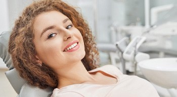 Female patient smiling after dental implant salvage in Somerville, NJ