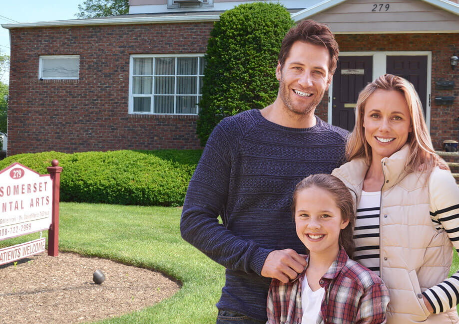 family smiling outside