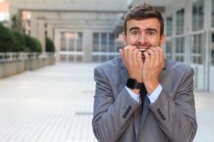 man biting nails out of fear