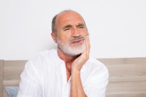 an older man experiencing gum pain