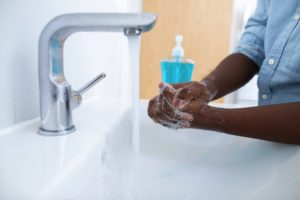 Man washing hands according to dentist in Somerville