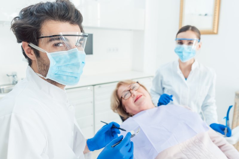 Dentist in Somerville, NJ wearing PPE with patient