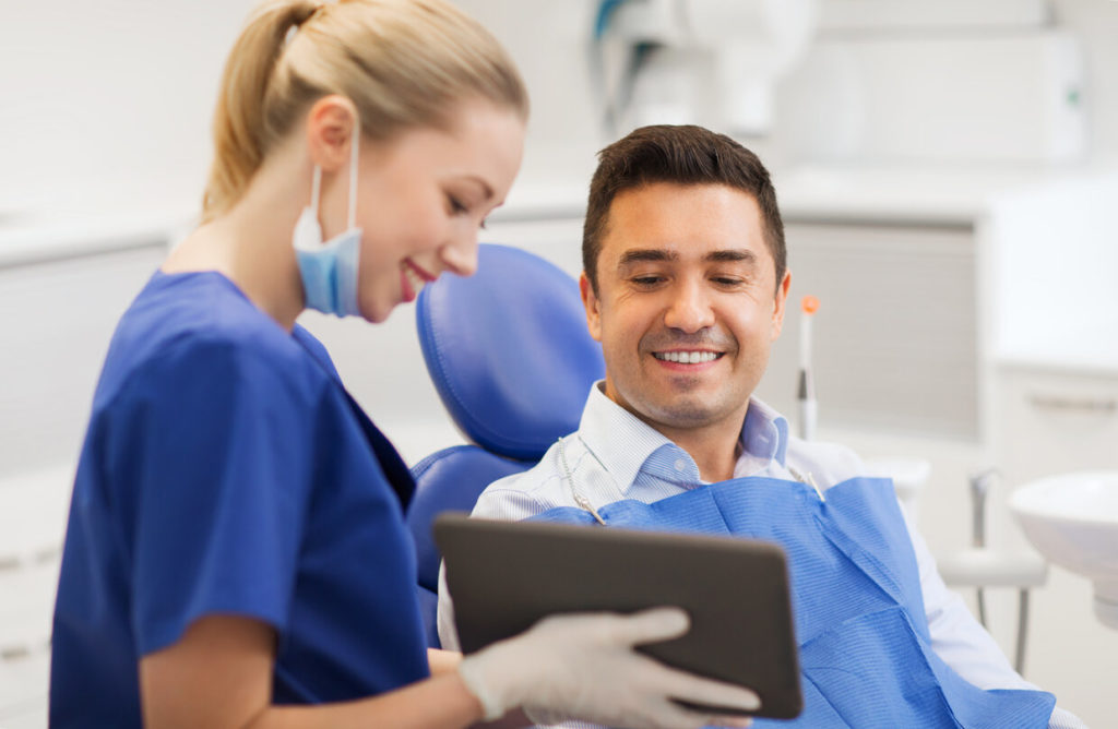 patient speaking with their dentist about dental implants in Somerville