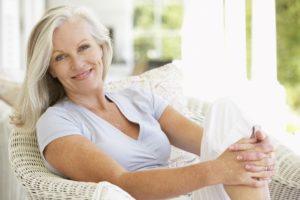 Older woman sitting in patio chair