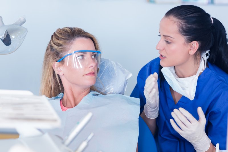 person talking to dentist about removing a failed dental implant 