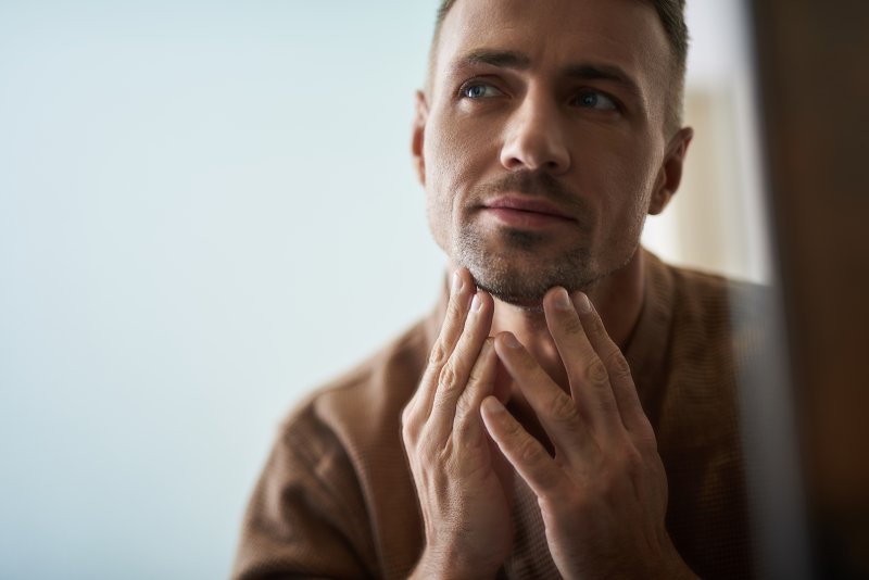 Patient checking jaw after TMJ treatment